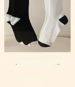 Detail of ribbed knit texture on black and white mid-calf cotton crew socks