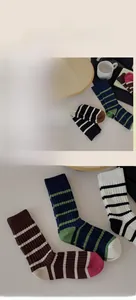 Close-up of colorful striped cotton socks showing soft ribbed texture and vintage knit style