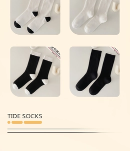 Detailed view of mid-calf cotton socks in four black and white colorways with ribbed texture