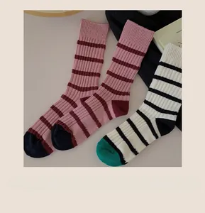 Close-up of striped knit crew socks with reinforced toe and ribbed cuffs in retro style