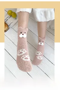 Detail of pink coral fleece thermal socks featuring 3D cartoon bear ears and cute embroidery
