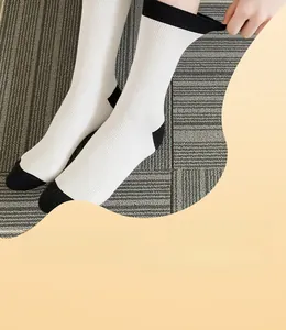 Detail of black and white ribbed crew socks with high elasticity and secure cuff