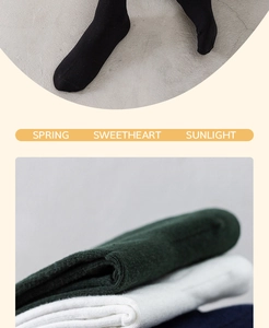 Close-up of ribbed cotton socks in black, white, and green with a soft knitted texture