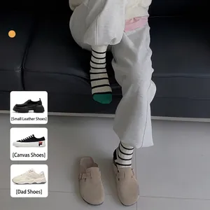 Women's retro striped mid-tube socks with green toe accent and cozy cotton texture