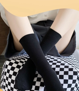 Close-up of black ribbed crew socks with vertical knit texture and soft elastic fit