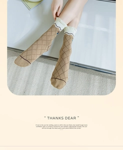 Detailed macro view of khaki cotton socks featuring rhombus patterns and ruffled cuffs