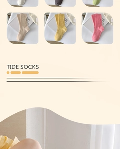 Detail of colorful cotton crew socks showing TS embroidery and various candy colors
