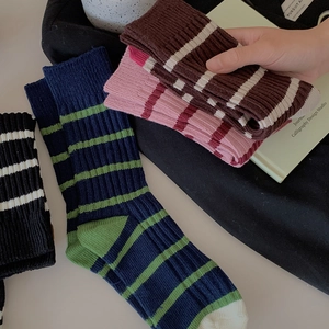 Classic striped cotton mid-calf socks in various colors with thick ribbed knit texture