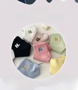 Detail of seven colored cotton socks with ribbed elastic cuffs and H letter embroidery