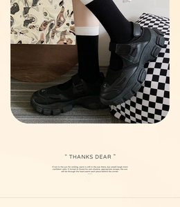Detail of black platform Mary Jane sneakers with mesh panels and sporty Velcro straps