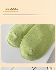 Detailed macro view of green cotton knitted toe seam with rib texture on mid-tube sock