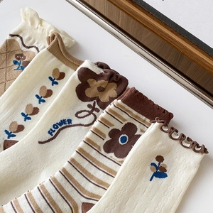 Vintage style cotton socks with floral patterns and ruffled edges in warm autumn tones