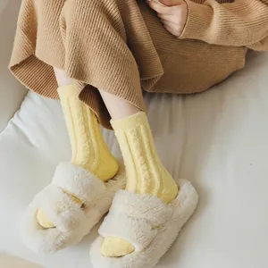 Warm yellow coral fleece socks with ribbed texture for winter thermal comfort