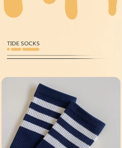 Detail of blue and white striped cotton socks featuring elastic cuffs and knit texture