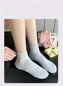 Close-up of ribbed cuffs on cotton sports socks with H letter embroidery in three colors