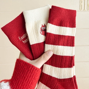 Festive red cashmere blend socks featuring striped patterns and cute cat embroidery details