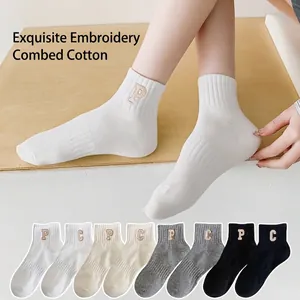 Breathable combed cotton crew socks with minimalist letter embroidery in multiple solid colors