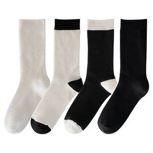 Set of four black and white ribbed mid-calf socks made of breathable cotton knit fabric