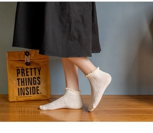 Detailed view of cream cotton socks featuring sweet lace trim and jacquard knit texture