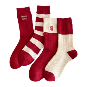 Set of four red cashmere blend winter socks with festive patterns and warm ribbed texture