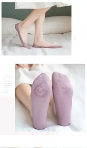 Detail of purple lace invisible boat socks showing non-slip sole with heart patterns