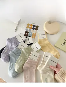 Detail of ribbed knit cotton crew socks in pastel macaron colors with hello embroidery