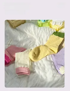 Detail of colorful rib-knit crew socks in macaron tones with contrast trim design