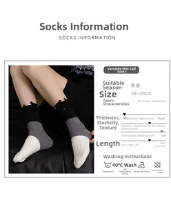 Close-up of black and white striped crew socks with distressed hole and fringe detail