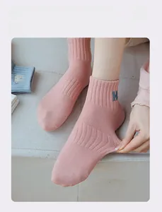 Detailed shot of pink knit sock featuring H letter embroidery and high elastic stretch