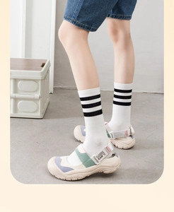 Detail of colorful sporty Mary Jane sandals with striped socks and anti-collision toe cap