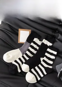 Detail of striped cotton crew socks with ribbed texture over a premium leather background