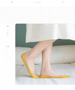 Detailed view of yellow seamless invisible boat socks worn on feet in a cozy home setting
