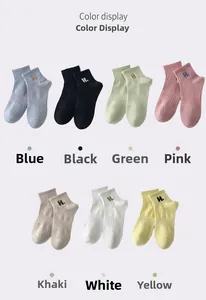 Close-up of cotton ankle socks with H letter embroidery in seven vibrant colors