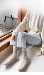 Detail of bunny embroidery on ribbed beige crew socks with 200N high-count cotton texture