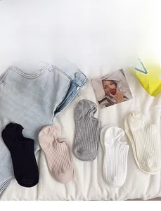 Close-up of five pairs of ribbed low cut invisible socks in neutral colors with non-slip heel
