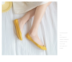Close-up of a woman wearing bright yellow breathable cotton low-cut invisible liner socks