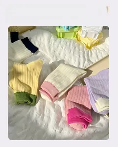Macro shot of colorful ribbed knit crew socks in various pastel color blocking styles