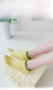 Detail of soft cotton low cut sock with smile embroidery and 200N fine knit texture
