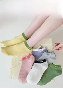 Detail of colorful cotton ankle socks with white Smile embroidery and elastic cuffs