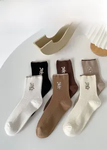 Set of six ribbed mid-calf socks with cute bunny embroidery in various earthy tones