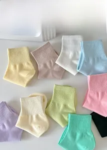 Detailed flat lay of colorful cotton socks showing ribbed elastic cuffs and soft fabric texture