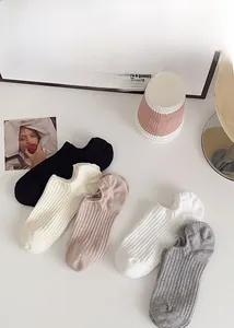 Detail of five multi-colored ribbed invisible boat socks in soft cotton knit fabric