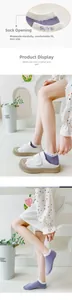 Detail view of purple cotton socks with Smile embroidery and heart pattern on the cuff