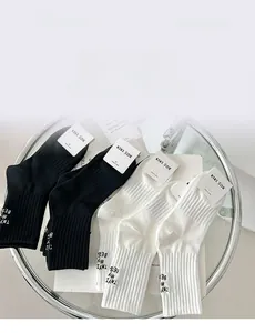 Detail of ribbed knit crew socks with Try My Best lettering and retail packaging