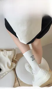 Detail of 200N high-density white cotton socks with black Trying My Best letter embroidery