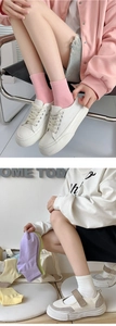 Close-up of colorful pastel cotton mid-tube socks paired with casual canvas shoes