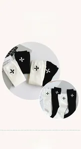 Detail showing soft cotton knee high socks with minimalist floral embroidery accents