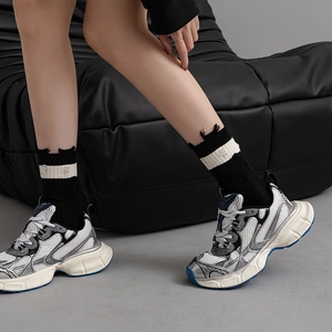 Retro platform sneakers with white and blue mesh panels shown from a side dynamic view