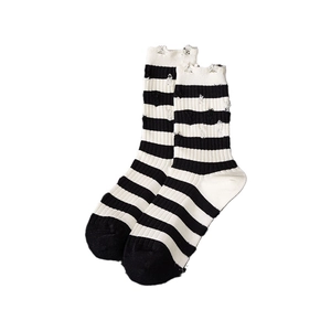 Street style ripped mid-calf socks with black and white stripes and distressed holes