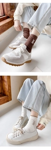 Detail of embroidered rabbit mid-calf socks paired with retro sneakers and casual shoes